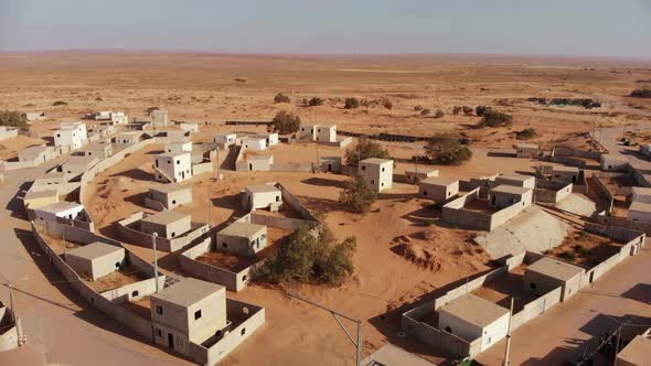 aerial shot revealing soldiers walks at palestine near gaza in the desert at an empty city.