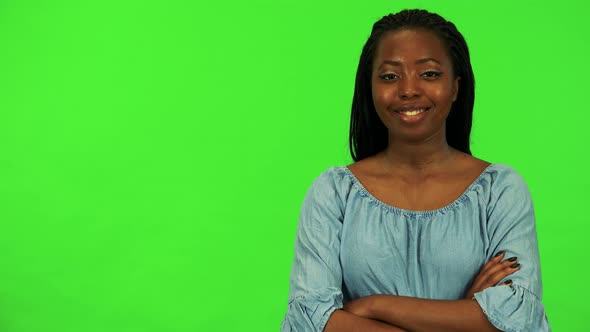 A Young Black Woman Smiles and Shows a Thumb Up To the Camera - Green Screen