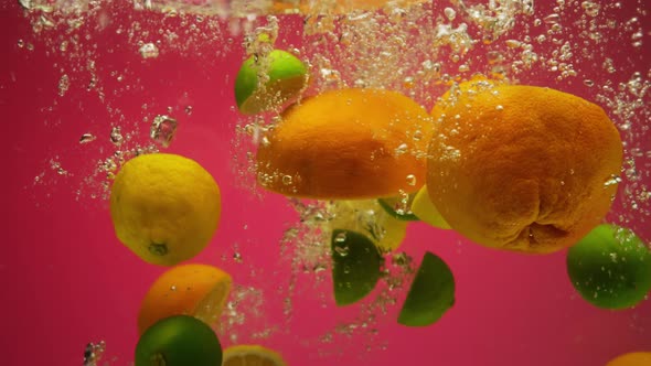 Mix of Exotic Citrus Fruits Falling Into Water in Slow Motion  Grapefruit Lemon Orange Lime