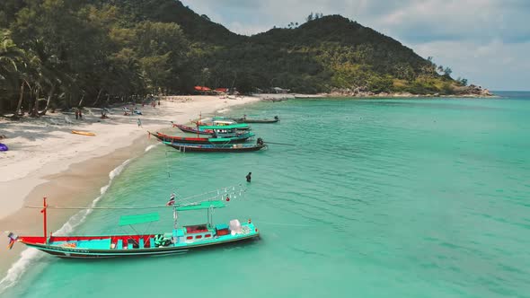 Traditional Colorful Boats on Sandy Beach Shore in Koh Phangan Exotic Island in Thailand