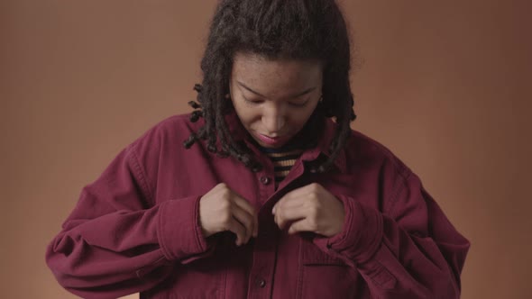 Charming African-American Woman Buttoning Shirt Up