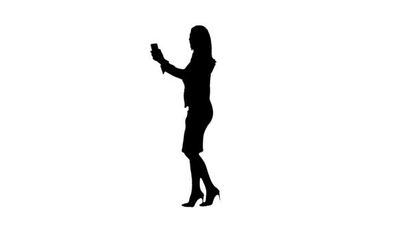 Woman Walks By Video and Talk. Side View. White Background. Silhouette . Slow Motion