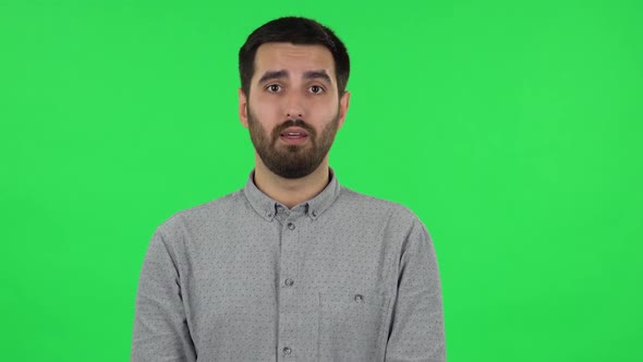 Portrait of Brunette Guy Is Reporting and Telling a Lot Information. Green Screen