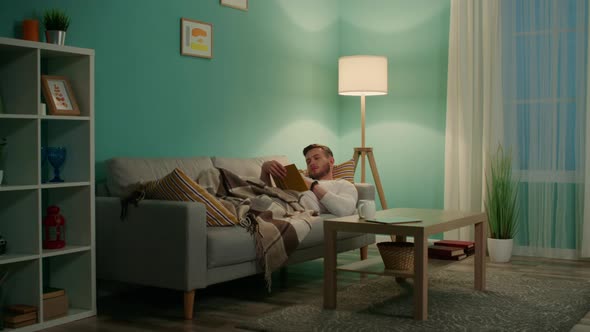 Young Man Is Relaxing With Book