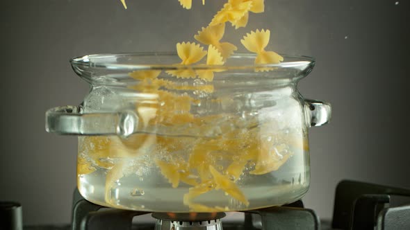 Super Slow Motion Shot of Fresh Farfalle Falling Into Boiling Salted Water at 1000 Fps