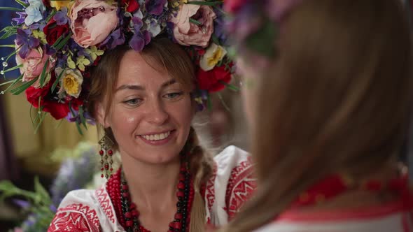 Closeup Portrait of Happy Ukrainian Mother Admiring Little Daughter in National Costume and Head