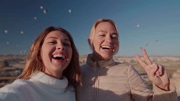 Close-up Lifestyle Portrait of Young Best Friends Girls Having Fun at Cappadocia