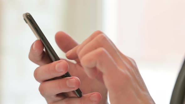 Close Up of Middle Aged Businessman Using Smartphone Mobile