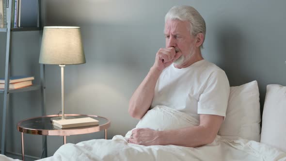 Sick Old Man Coughing in Bed 