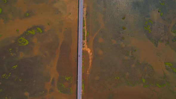 Drone video of the road leads through a large beautiful wetland.