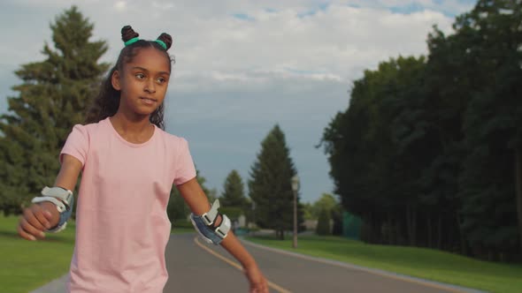 Teenage Girl on Roller Skates Enjoying Ride in Park