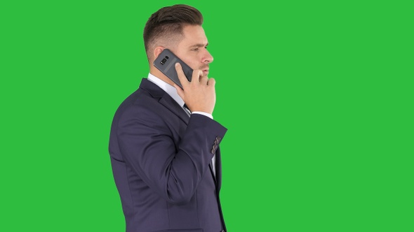 Businessman talking on the phone on a Green Screen, Chroma Key.