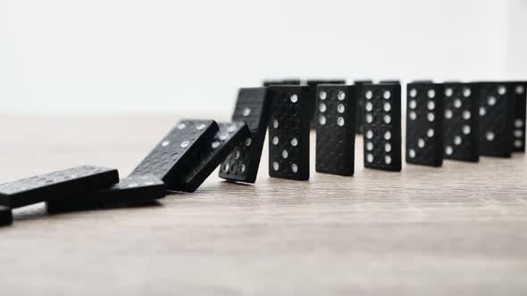 Domino Effect in Slow Motion  Falling Black Tiles with White Dots