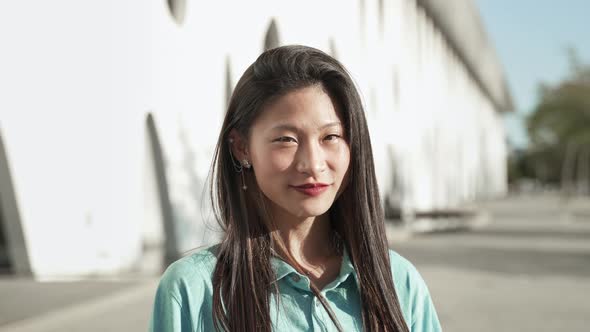 Portrait of Happy Asian Young Teenager Female Student Smiling and Looking at Camera with Positive