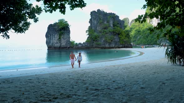 Couple Men and Woman on the Beach of Koh Hong Island Krabi Thailand Asian Woman and European Men on