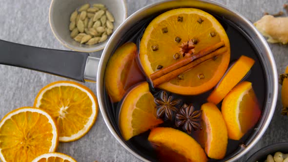 Pot with Hot Mulled Wine, Orange Slices and Spices 