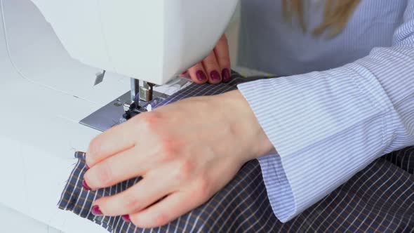 Seamstress Woman Works on Sewing Machine