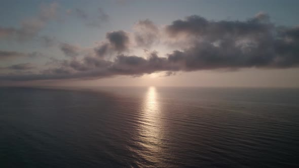 Sunrise over the sea. Epic view of the ocean and reflection of clouds and sun.