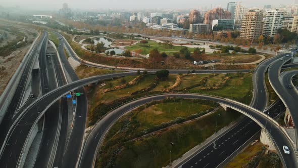 Aerial view going from a highway junction getting into Bicentenario park in Santiago city