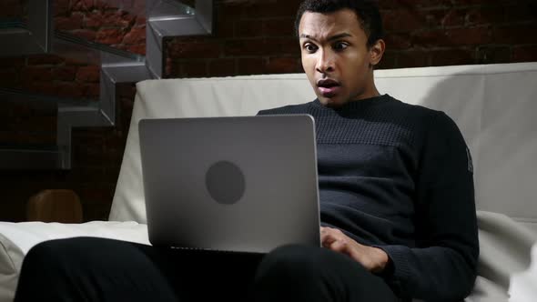Shocked Man Amazed By Surpriseand Wonder on Laptop