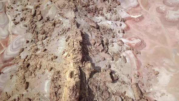 Aerial view looking down at rocky desert terrain in Mars like landscape