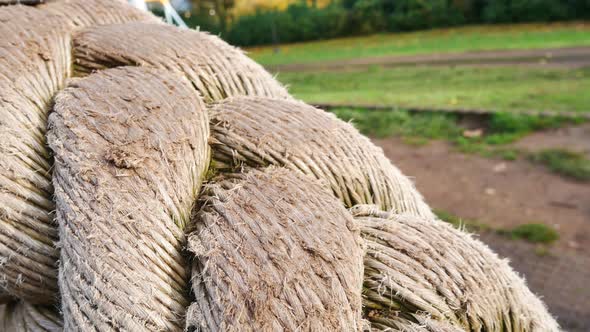 Slow panning reveal shot of rope ride in empty children's playground in autumn.