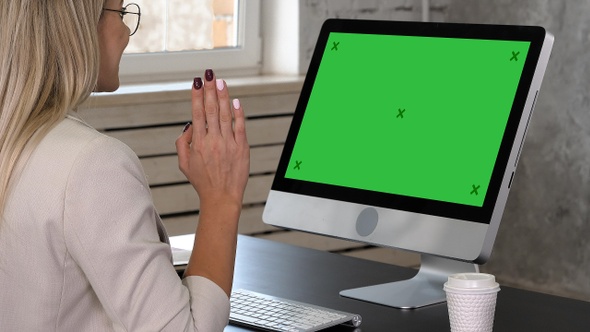 Businesswoman making video call to business partner. Green