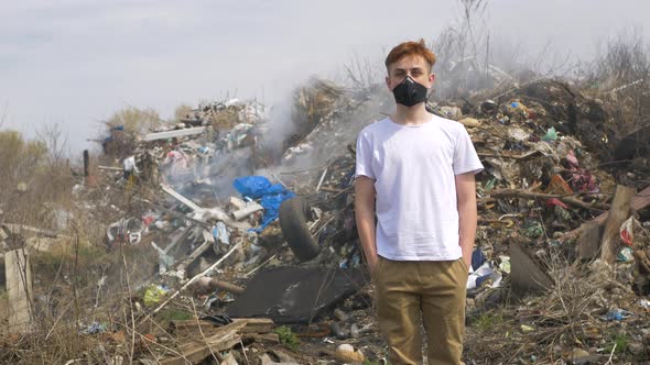 Portrait of young guy in a medical mask looks at camera