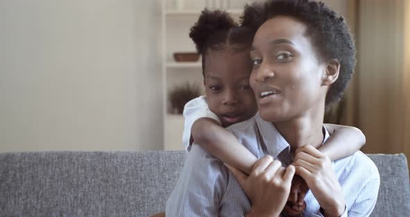 Portrait of Two People African Mom and Cute Little Preschool Daughter Talking Laughing Smiling