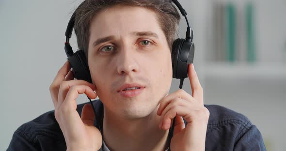 Portrait Caucasian Man Millennial Calm Guy Wearing Modern Wireless Headphones Listening to Music