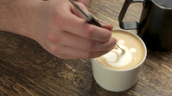 Hand with Latte Art Pen.