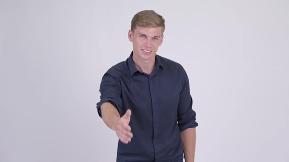 Happy Young Handsome Blonde Businessman Giving Handshake