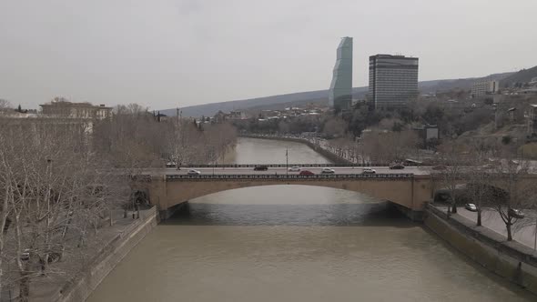 Aerial View of Galaktion Tabidze Bridge over Kura river in the centre of Tbilisi. Georgia 2021 April