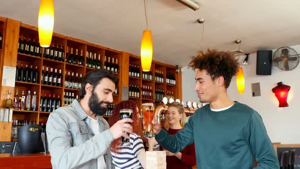 Male friends playing jenga while having beer 4k