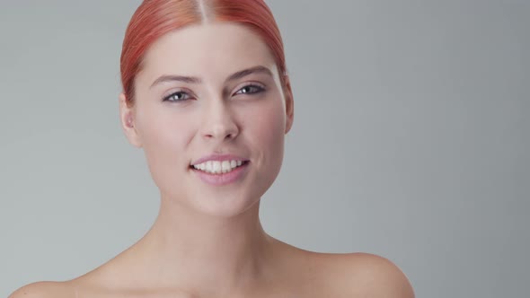 Studio portrait of young, beautiful and natural redhead woman. Beauty concept.