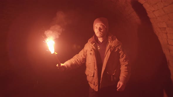 Man with Red Flare Torch walking through Medieval Dungeon Tunnel