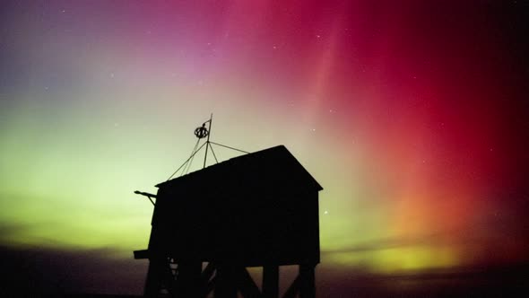 northern lights (aurora borealis) at the shipwreck shelter on the dutch island of Terschelling