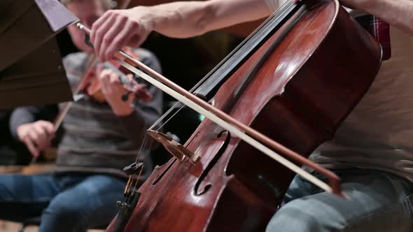 A close-up of the double bass strings as the bow slides