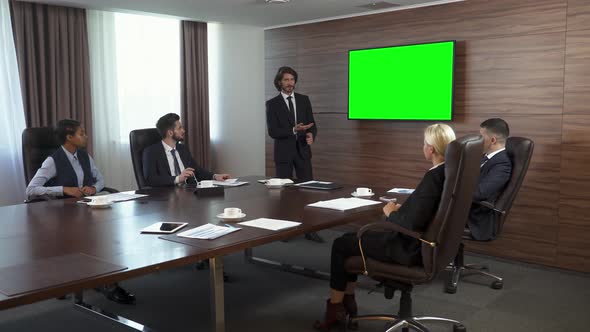 Business Meeting, a Young Businessman Speak at a Meeting and Shows a Presentation in the Conference