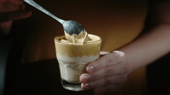 Woman hands holding dalgona coffee with almond milk and brown sugar