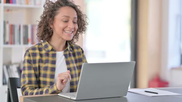 Online Video Chat on Laptop By Young Mixed Race Woman at Work