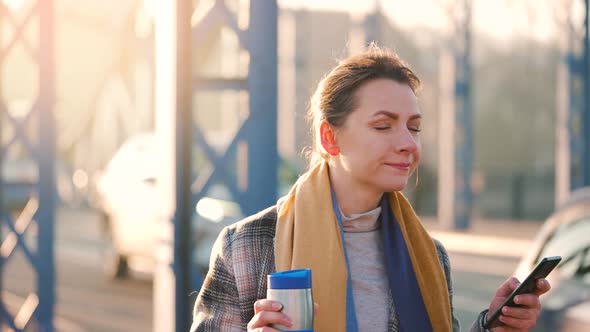 Portrait of a Young Caucasian Businesswoman in a Coat Walking Around the City on a Frosty Morning