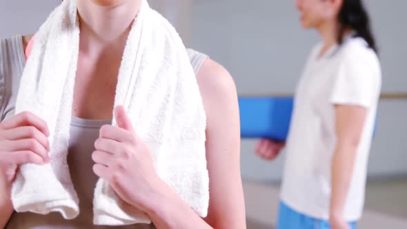 Portrait of woman standing with towel