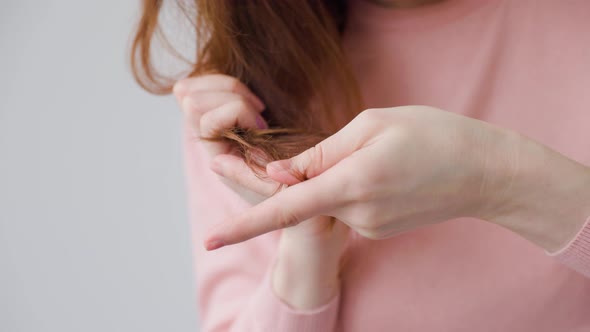 Close Up of a Woman Hands with Hair Problems