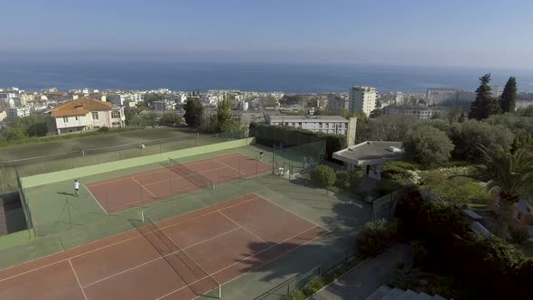 Aerial View of City and Luxury Court, People Playing Tennis, Hobby and Relax