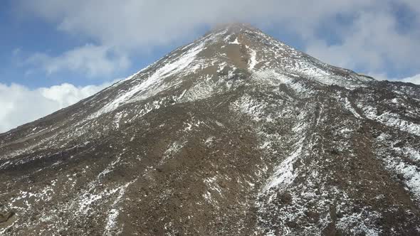 Aerial View of the Summit of the Teide Volcano on Tenerife, Covered with Snow and Clouds