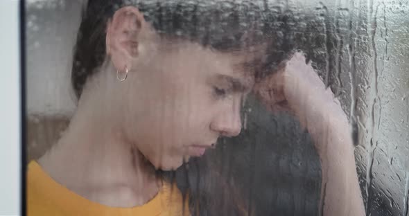 Emotional Girl Look at Rain