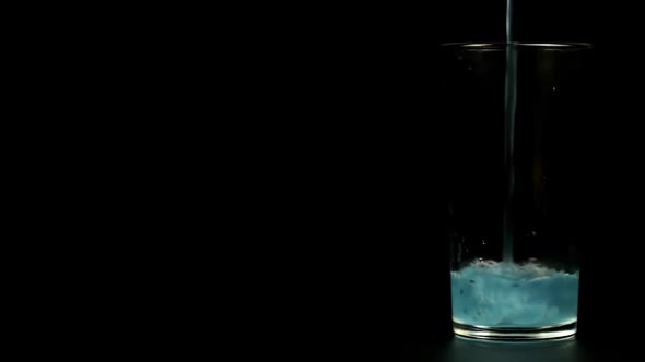 Turquoise Cocktail Is Poured Into A Glass On A Black Background