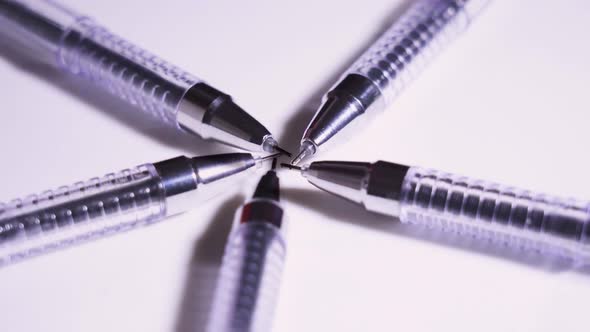 Many Spinning Pens on the White Table