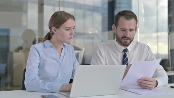 Executive Business People Working on Documents and Laptop